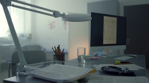 Working Computer Standing Doctor Desktop in Empty Medical Cabinet Close Up