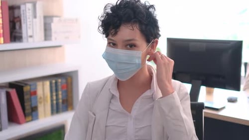 Portrait of business woman take hygiene mask off and stay in the office with day light