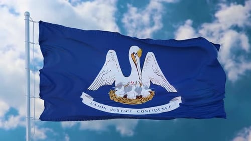 Louisiana State Flag Waving in Wind Against Blue Sky