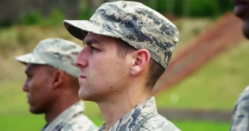 Soldiers in Camouflage Uniforms Standing Outside