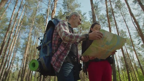 Couple Hikes Through Forest, Reads Map