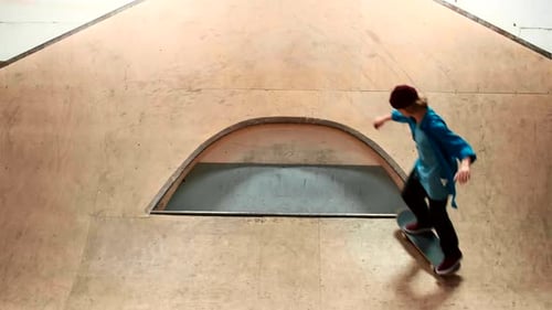 Teen Skateboarding Grind Trick on Rail