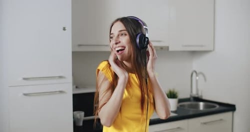 Young Woman Dancing to Music at Home