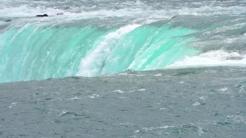Streams of Water Fall Down Against the Background of Clear Blue Sky