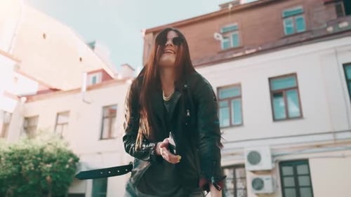 Young Happy Beautiful Girl Is Smiling and Dancing Emotionally on the Street of the City.