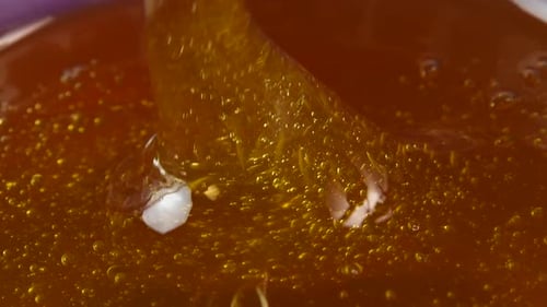 Pouring Liquid Honey in a Bowl