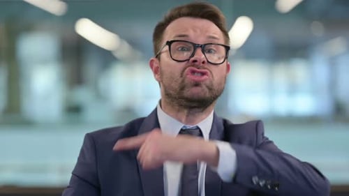 Man in Suit Argues and Gestures Angrily