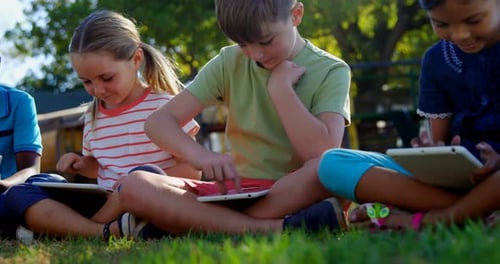 Kids using digital tablet in the playground 4k