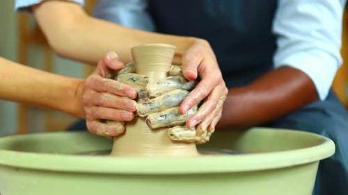 Mixed Race Hands Couple Making Vase in Art Studio