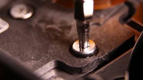 Screwdriver Unscrewing Screw From Hard Drive Component