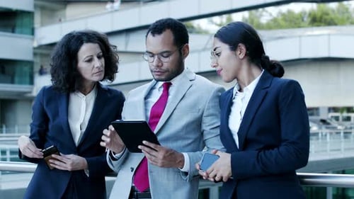 Team Discussing Technology in Modern City Setting