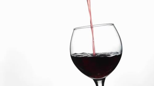 Pouring Red Wine into a Crystal Wine Glass