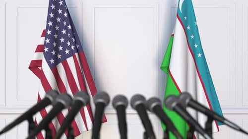 United States and Uzbekistan Flags on Podium with Microphones