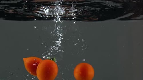 Cherry Tomatoes Dropping into Water