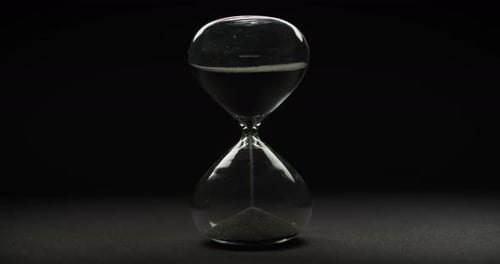 Black Sand Hourglass Countdown on Dark Background