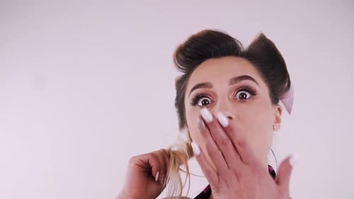 Glamorous Woman in Hair Rollers Reacts with Surprise