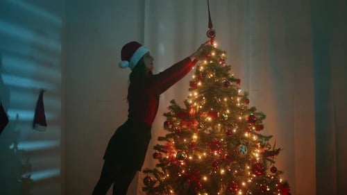 Woman Decorating Beautiful Christmas Tree at Home