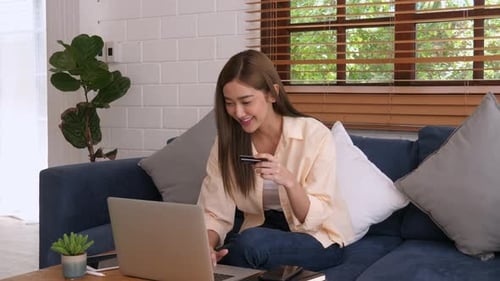 Young Woman Shopping Online with Credit Card