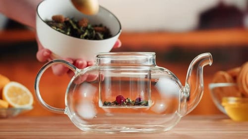 Adding Herbal Tea to a Clear Glass Teapot