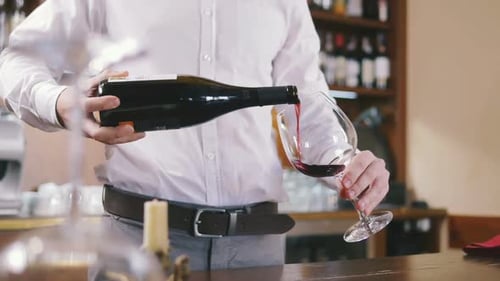 Sommelier Filling Glass with Wine in Restaurant Close Up Slow Motion
