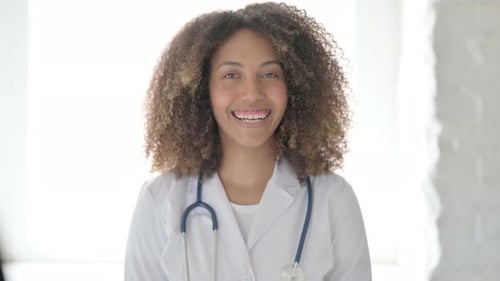 Doctor Smiling in Lab Coat with Stethoscope
