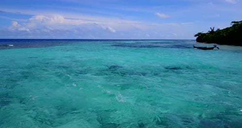 Beautiful above travel shot of a paradise sunny white sand beach and aqua blue water background in v