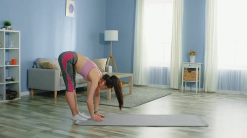 Slim Woman Makes a Deep Breath After Forward Bend