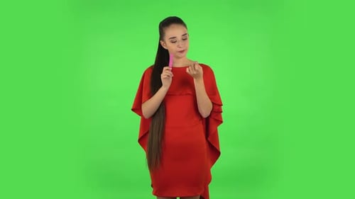 Pretty Young Woman Is Making Herself Manicure with Pink Nail File. Green Screen