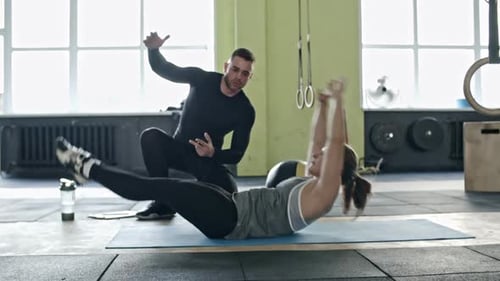 Woman Doing Abs Exercise with Personal Coach