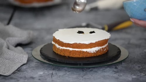 Cake Being Decorated With a Spoon