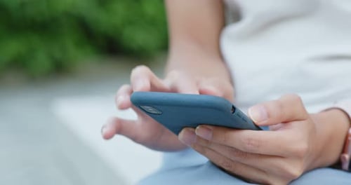 Woman Using Mobile Phone in City, Close Up