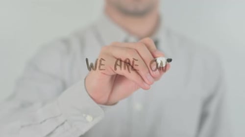 Man Writes 'We Are One' on Glass