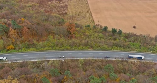 Aerial Top View of a Road in the Middle of the Mountains Forest