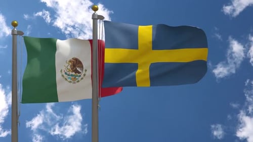 Waving Flags of Mexico and Sweden Against Blue Sky