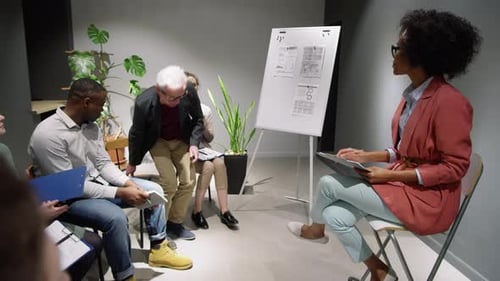 Colleagues Collaborate in Office Meeting Presentation