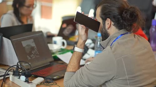 Junge amerikanische Mitarbeiter arbeiten an einem Online-Projekt am Tisch mit Laptops in Firma Irrl