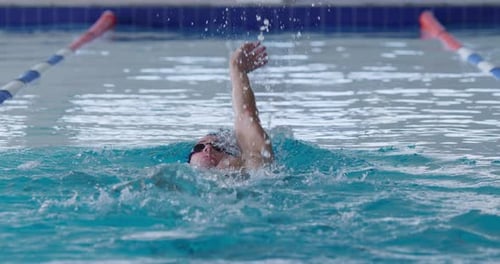 Swimmer swimming into the pool