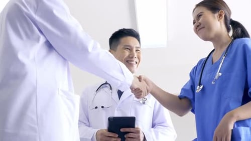 Team of doctors talking in hospital. Group of medical staff discussing in clinic.