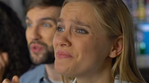 Friends Watching a Competition, Looking Distressed