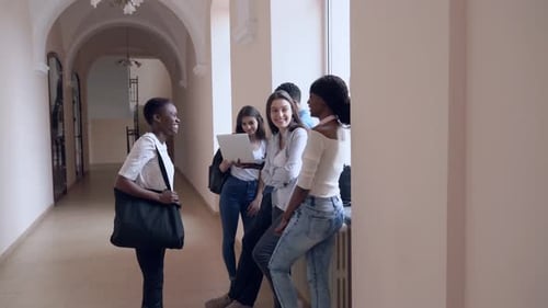 Students Talking in Corridor During Break in College
