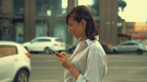 Adult Woman Using Mobile Walks in City