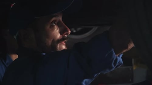 Young man is mechanic repair car in the garage with professional, auto service.