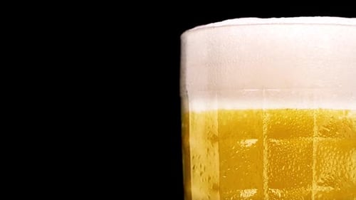 Close Up of Beer with Bubbles and Foam