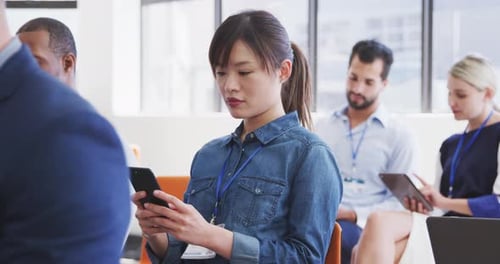 Adults Attending Meeting Using Phones and Tablets