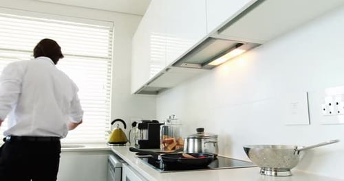 Man Cooking Spaghetti in Modern Kitchen