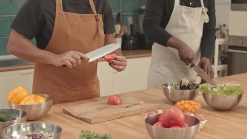 Adults Preparing Vegetables in Bright Kitchen at Home
