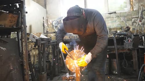 Arbeiter im Schutzmaskenschweißen Metallbau in der industriellen Produktion