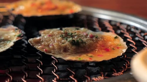 Big Fresh Scallop Shell Seafood Grill on Metal Net with Charcoal Barbecue in Korean Restaurant