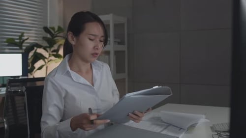 Woman Working at Her Desk Receives New Documents