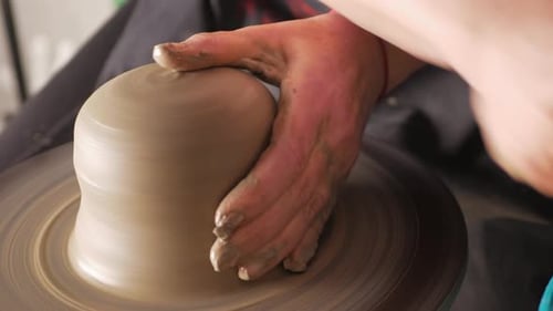 An Elderly Woman Senior Professional Potter in Workshop Makes Jug Out of Clay